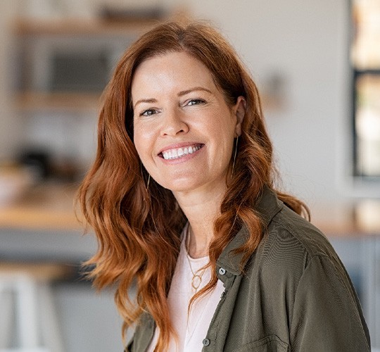 Closeup of woman with auburn hair smiling
