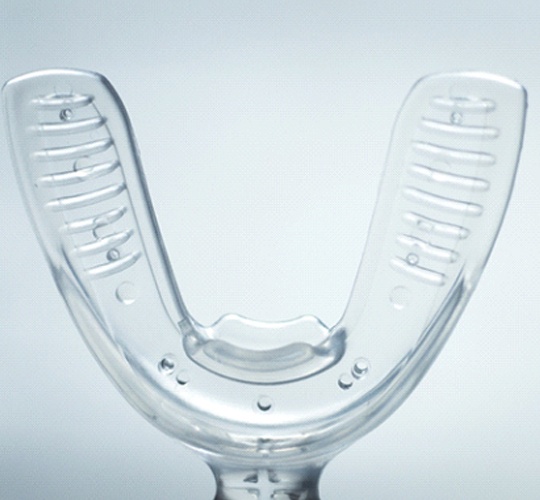 A U-shaped, clear, oral device that is used to gently move aligners into their proper position