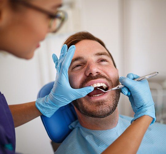 man getting a dental cleaning