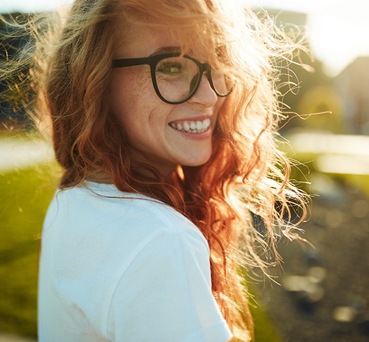 smiling woman who understands the cost of cosmetic dentistry in Westport