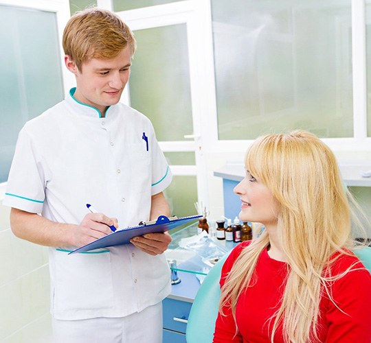 Woman learning about veneers in Westport