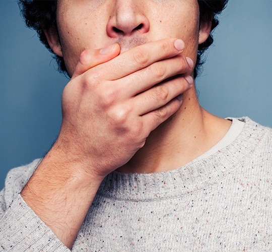 man covering mouth