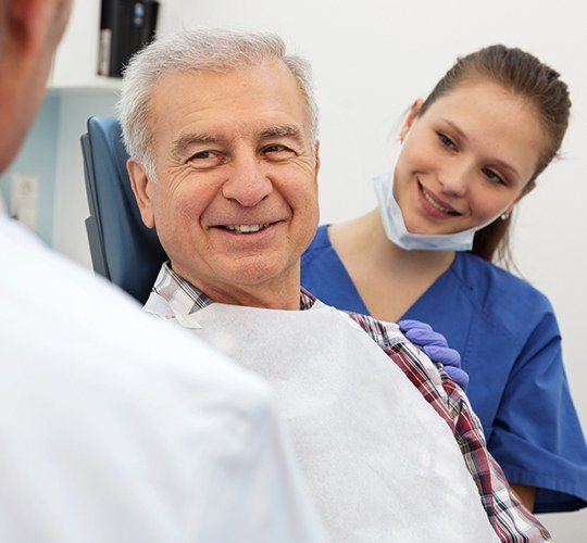 older man smiling at dentist