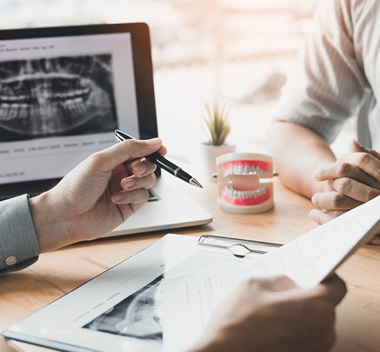 a dentist going over a treatment plan with a patient