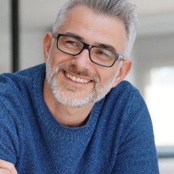 man smiling with arms crossed 