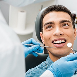 a man having his teeth examined by a dentist