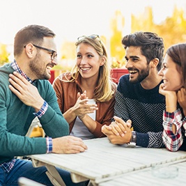 friends sitting on a patio talking