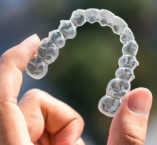 hand holding invisalign