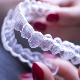 closeup of person cleaning clear aligner 