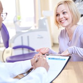 A young woman discussing with her dentist