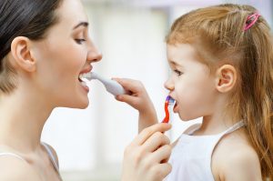 mother and daughter brushing