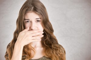 woman covering mouth