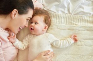 mother smiling at baby 