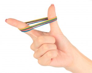 hand stretching a rubber band