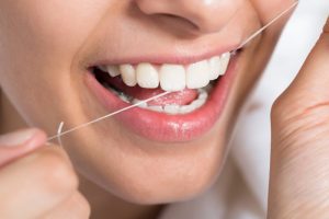 a woman flossing