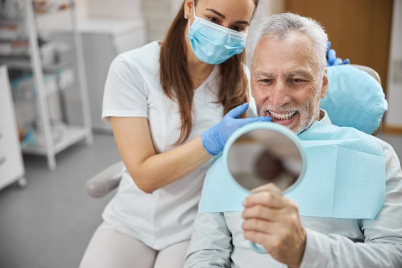 older man with dental implants