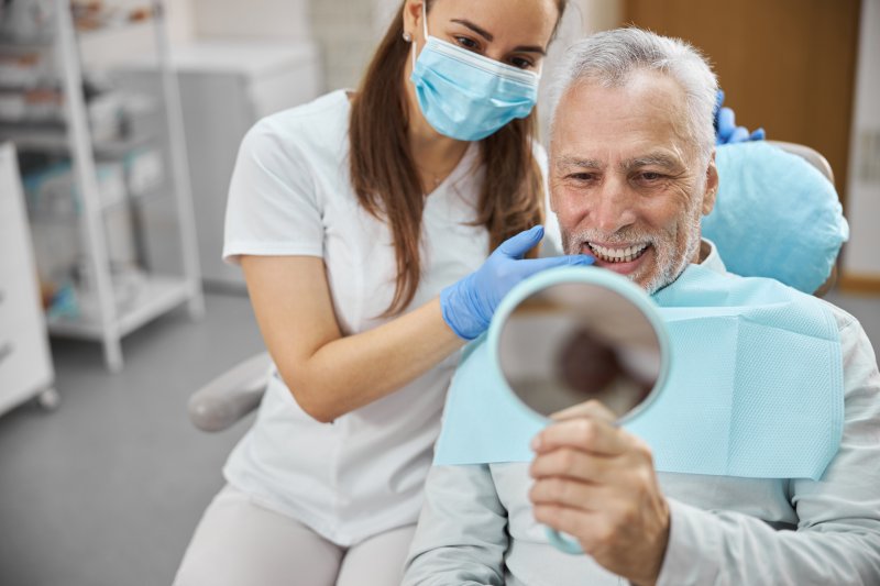 older man with dental implants