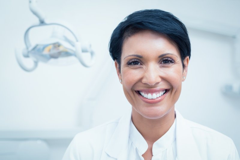 woman smiling while sitting in dentist office 