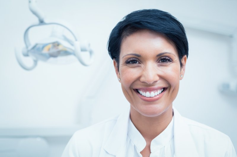 woman smiling while sitting in dentist office